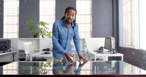 Professional African American Man Using Interactive Touchscreen Table in Office