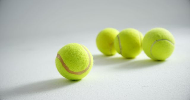 Close-up of Four Tennis Balls on White Surface - Download Free Stock Images Pikwizard.com