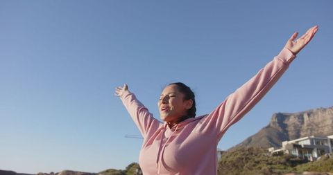 Woman embracing outdoors with recreational spirit by seaside