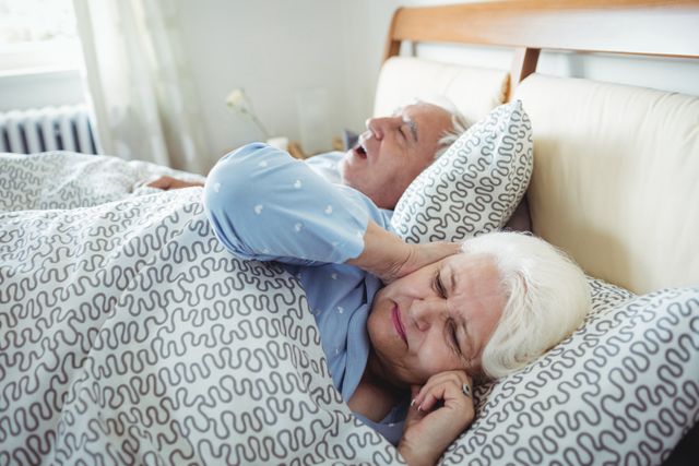 Elderly Couple in Bed with Snoring Husband and Frustrated Wife - Download Free Stock Photos Pikwizard.com