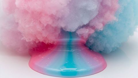 Pastel pink-blue cotton candy melting over glossy syrup puddle, macro confection closeup