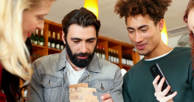 Friends Playing Jenga Game in Modern Cafe - Download Free Stock Images Pikwizard.com