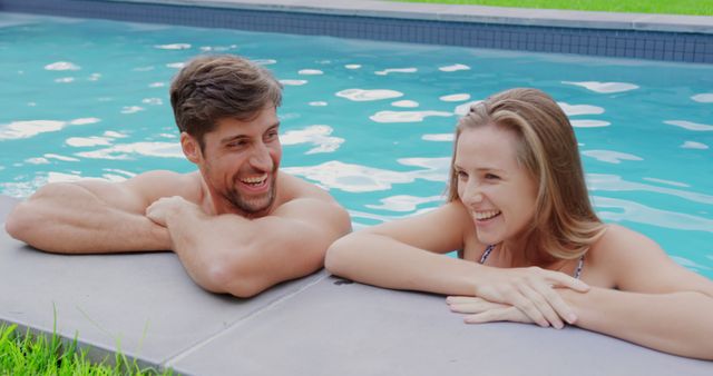 Young Couple Laughing and Relaxing in Pool - Download Free Stock Images Pikwizard.com