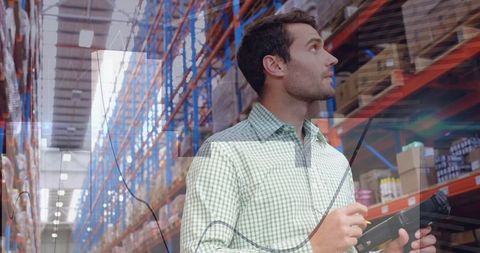 Warehouse worker scanning inventory racks in logistic hub