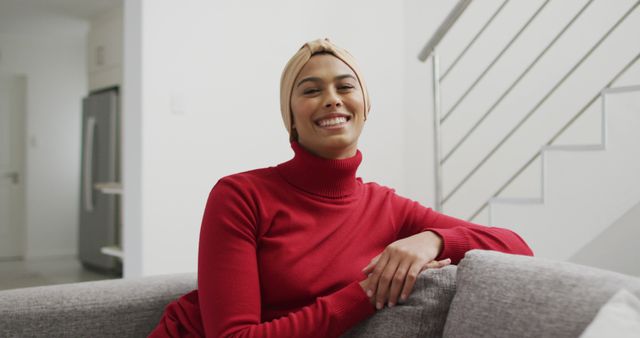 Smiling Young Woman in Red Turtleneck Relaxing on Couch - Download Free Stock Images Pikwizard.com