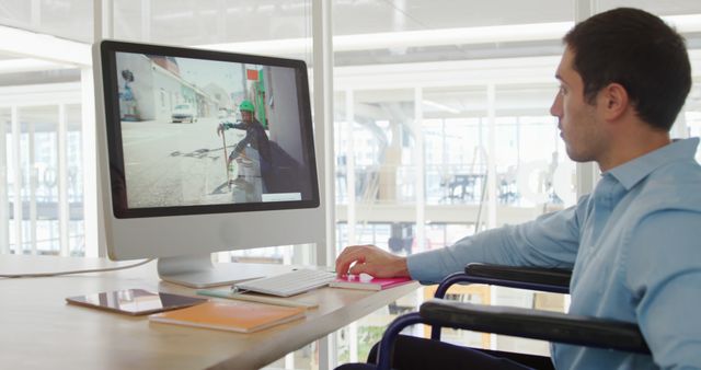 Office Worker in Wheelchair Viewing Construction Site on Monitor - Download Free Stock Photos Pikwizard.com