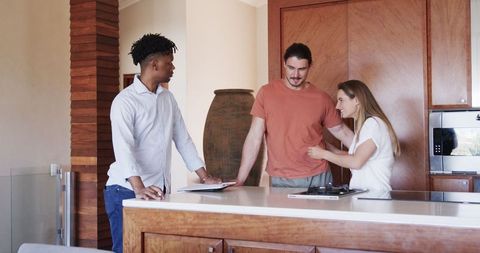 Friends in Modern Kitchen Sharing Ideas with Tablet