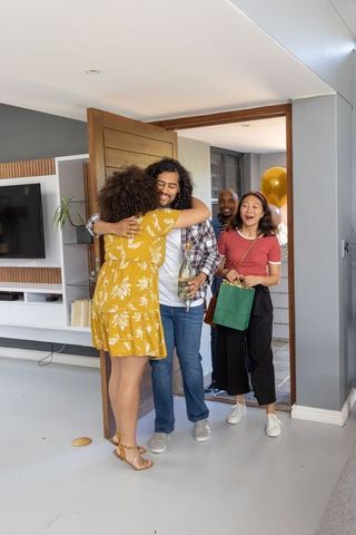 Warm Welcome: Diverse Friends Reuniting at Home Celebration