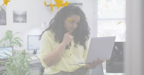 Professional Woman Engaged in Work with Laptop in Bright Office