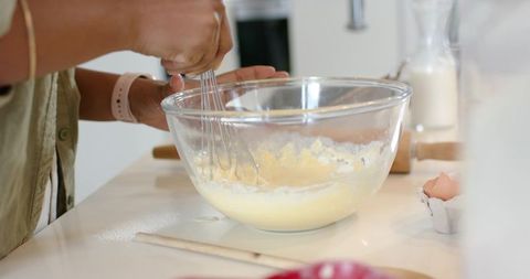 African American Couple Whisking Batter in Glass Bowl on Modern Kitchen Counter