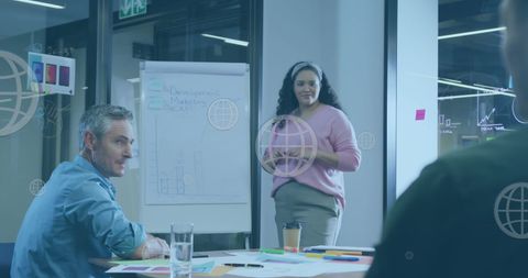 Professional woman presenting to team in modern office environment