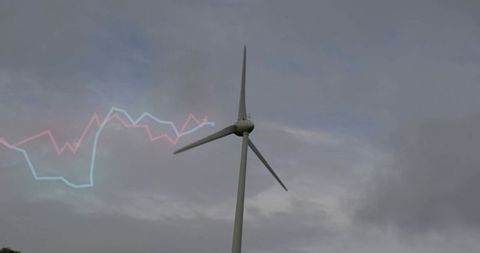 Utility-scale wind turbine spinning under moody clouds with pastel waveform overlay for energy data