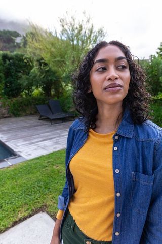 Woman Enjoying Peaceful Backyard Poolside Retreat
