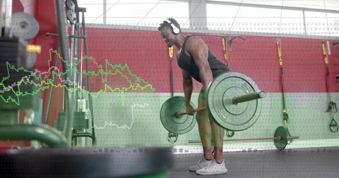 Male athlete performing barbell deadlift with analytics overlay in sunlit modern gym