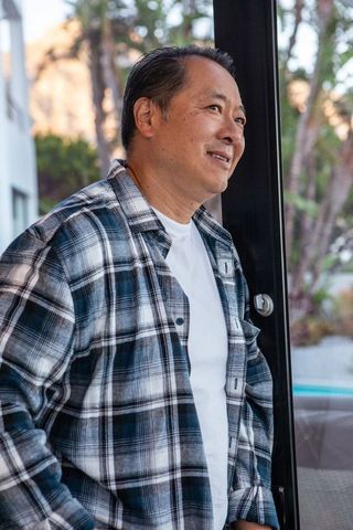 Mature Asian Man Relaxing at Home in Cozy, Modern Interior