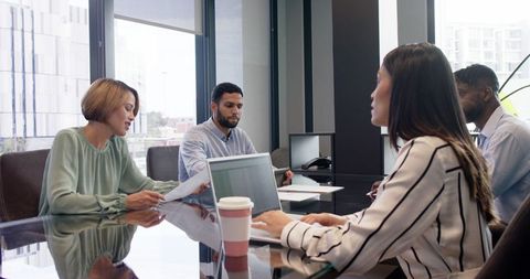 Professional Office Meeting with Diverse Team Discussing Projects