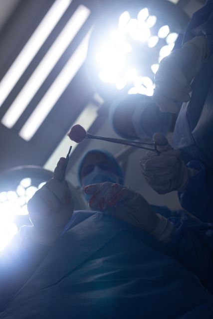 Surgeons performing operation in operation theater at hospital