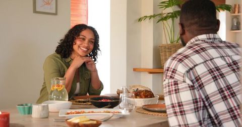 Diverse couple enjoying intimate dinner at home