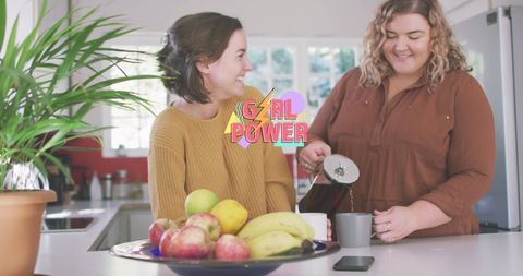 Empowered women enjoying coffee together in modern kitchen