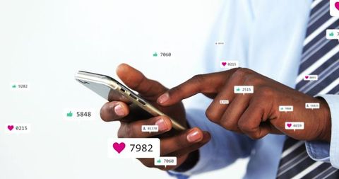 Businessman scrolling smartphone showing social media likes, comments and engagement metrics
