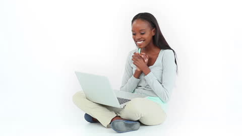 Joyful Woman Celebrating Success While Using Laptop