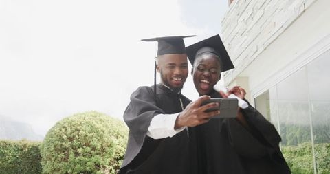Graduating Couple Celebrating Success with Joyful Selfie