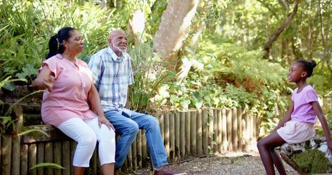 Grandparents Enjoying Day in Garden with Granddaughter