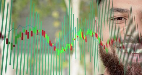 Smiling bearded man analyzing stock market green candlestick chart overlay on park pathway