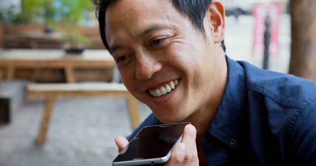 Smiling man talking on smartphone outdoors - Download Free Stock Images Pikwizard.com