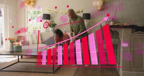 Senior son helping mother open birthday gift with augmented reality growth chart overlay