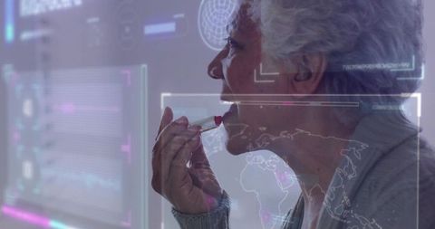 Senior woman applying lipstick with futuristic hud overlay and world map reflection