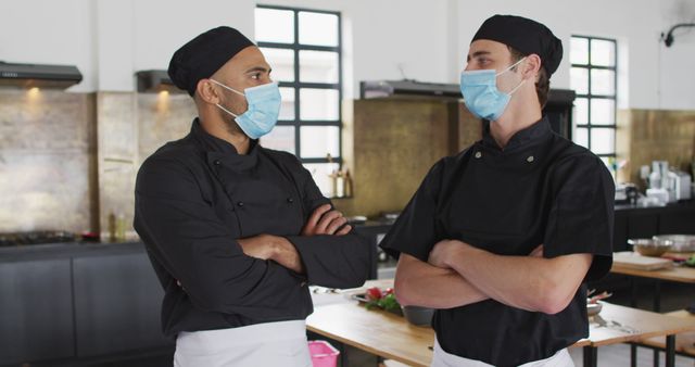 Chefs Wearing Masks and Discussing in Modern Kitchen - Download Free Stock Images Pikwizard.com