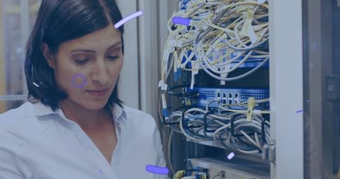 Woman monitoring server room for network stability