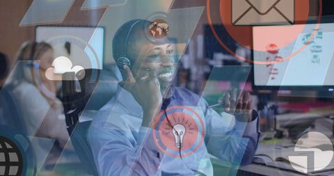 Smiling Businessman Using Headset with Digital Icons Overlay