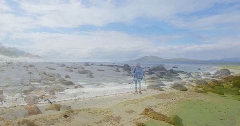 Senior Hiker Enjoying Serene Rocky Shore Adventures