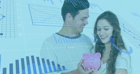 Young couple holding pink piggy bank with financial charts overlay for joint savings