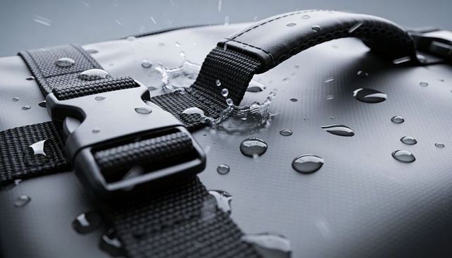 Waterproof travel bag close-up showing durable nylon webbing strap and quick-release buckle