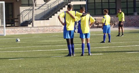 Youth soccer players celebrating success in bright yellow jerseys