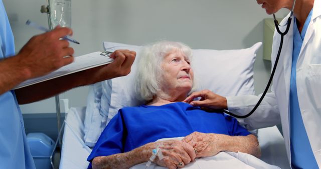 Elderly Woman Receiving Medical Assessment in Hospital Bed by Healthcare Professionals - Download Free Stock Images Pikwizard.com