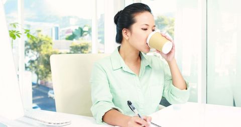Businesswoman Enjoying Coffee Break at Modern Office Desk - Download Free Stock Images Pikwizard.com