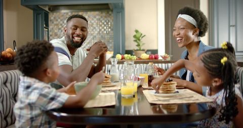 Happy African American Family Enjoying Breakfast at Home