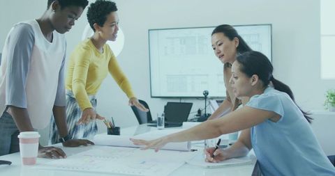 Professional Women Collaborating on Urban Blueprint Design