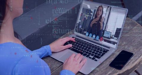 Remote team meeting with laptop video call and HUD code overlay for modern collaboration