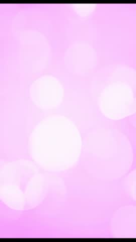 Vertical pink bokeh loop for mobile, dreamy luminous backdrop showing soft floating lights