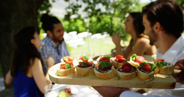 Friends Enjoying Outdoor Picnic with Fresh Bruschetta - Download Free Stock Images Pikwizard.com