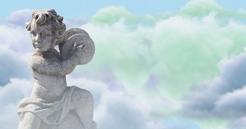 Stone Cupid Sculpture Amidst Ethereal Cloudscape