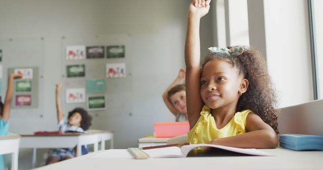 Image of happy african american girl raising hand during lesson - Download Free Stock Photos Pikwizard.com