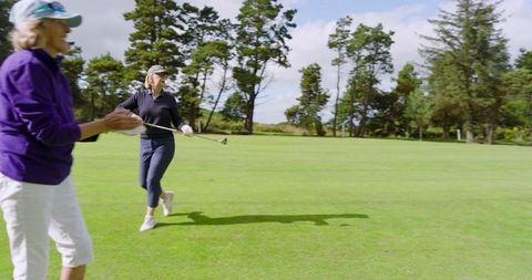 Senior Female Golfers Enjoying a Sunny Day on the Golf Course