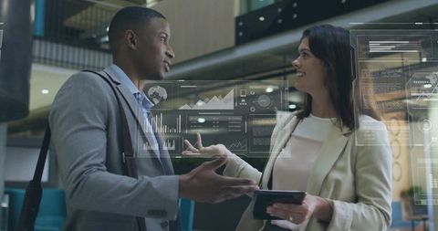 Colleagues discuss holographic data in modern lobby