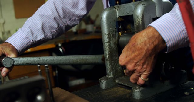 Elderly man operating vintage machinery in workshop - Download Free Stock Images Pikwizard.com